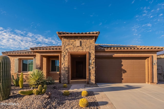 view of front facade featuring an attached garage, stone siding, driveway, and stucco siding