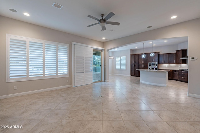 unfurnished living room featuring recessed lighting, visible vents, ceiling fan, and baseboards