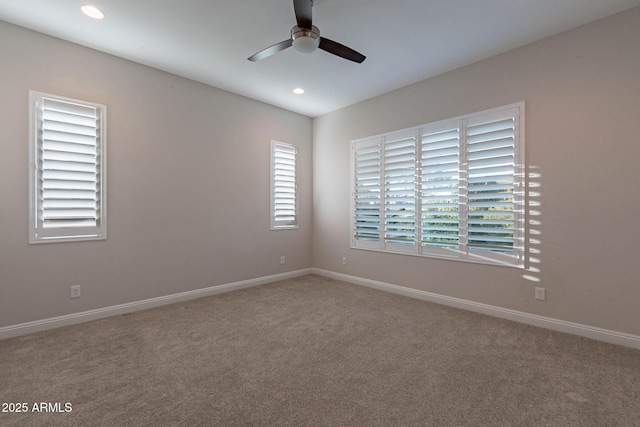 unfurnished room featuring a ceiling fan, carpet, and baseboards