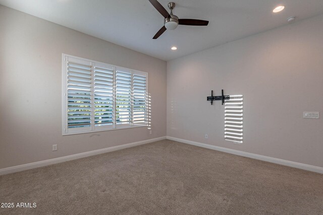 empty room featuring carpet floors, recessed lighting, and baseboards