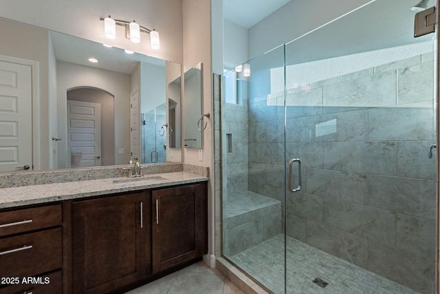 bathroom featuring a stall shower, vanity, and tile patterned floors