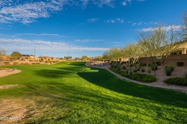 surrounding community featuring a lawn and golf course view