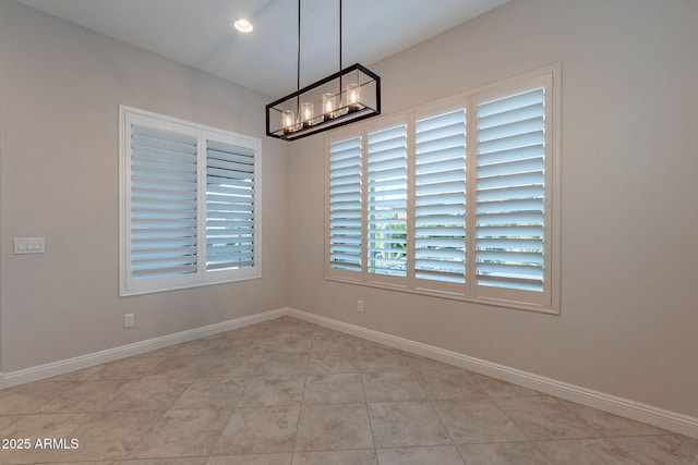 spare room with a chandelier, recessed lighting, baseboards, and light tile patterned floors