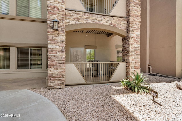 5450 E Deer Valley Dr Unit 1211, Phoenix, AZ 85054 - view of exterior entry featuring stone siding and stucco siding