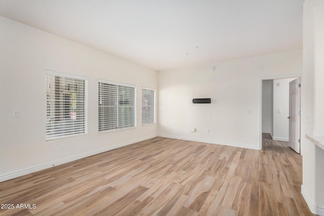 5450 E Deer Valley Dr Unit 1211, Phoenix, AZ 85054 - unfurnished room featuring light wood-style flooring and baseboards