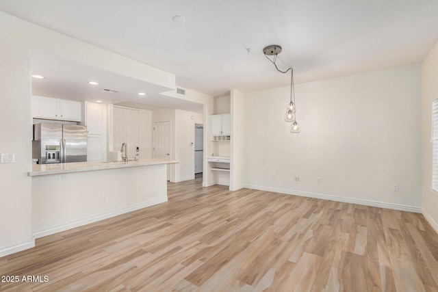 5450 E Deer Valley Dr Unit 1211, Phoenix, AZ 85054 - unfurnished living room featuring light wood-style flooring and recessed lighting