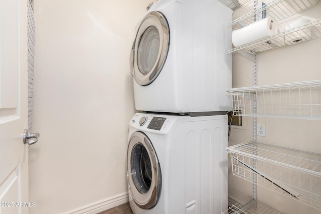 5450 E Deer Valley Dr Unit 1211, Phoenix, AZ 85054 - laundry room with estacked washer and dryer and baseboards
