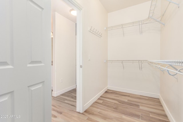 5450 E Deer Valley Dr Unit 1211, Phoenix, AZ 85054 - walk in closet featuring light wood finished floors