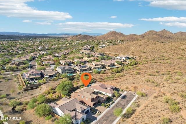 birds eye view of property with a mountain view