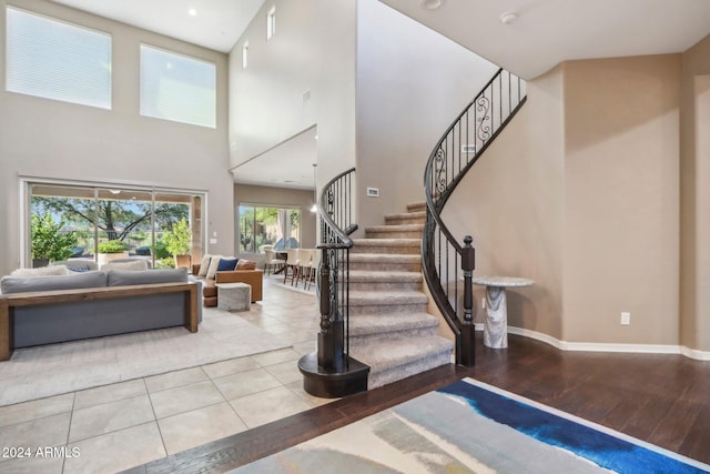 interior space with a high ceiling and hardwood / wood-style floors