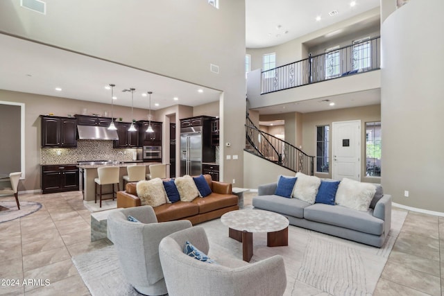 living room with light tile patterned flooring and a high ceiling