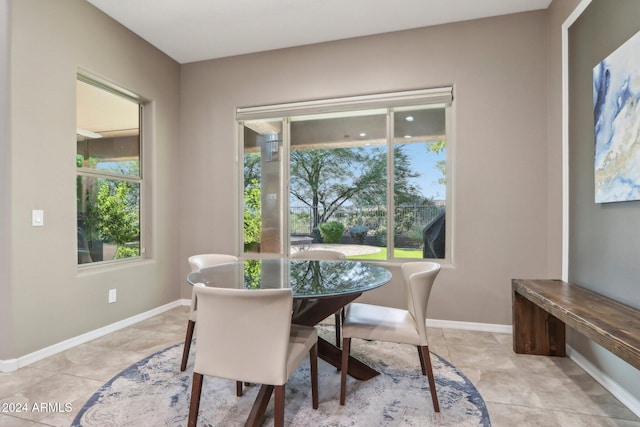 dining space featuring light tile patterned floors