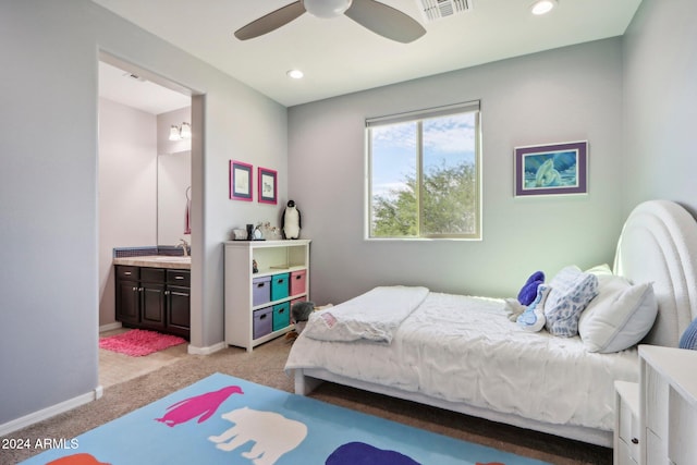 carpeted bedroom with connected bathroom, sink, and ceiling fan