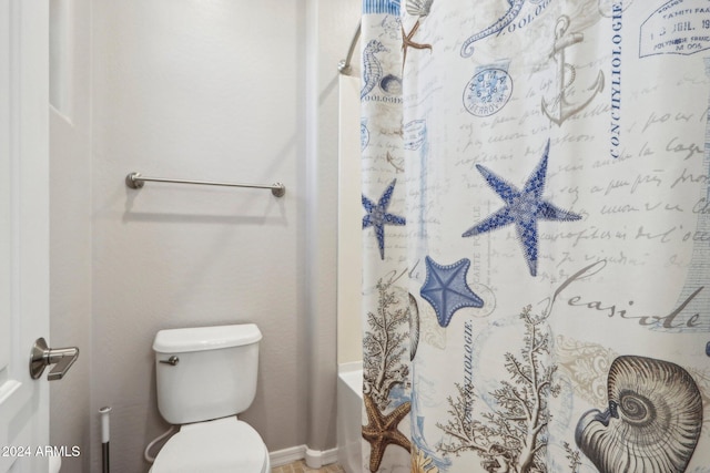 bathroom featuring toilet and shower / tub combo