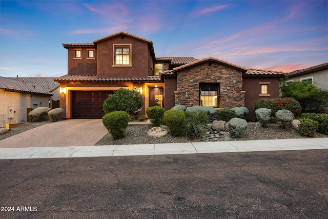 mediterranean / spanish home featuring a garage