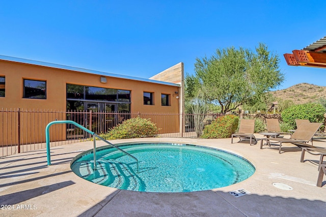 view of pool featuring a patio and a mountain view