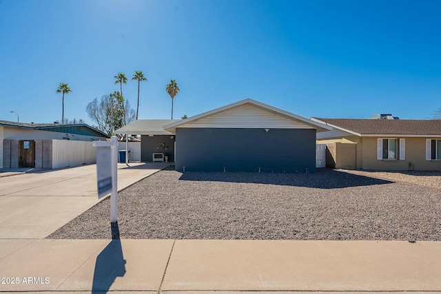 single story home featuring fence