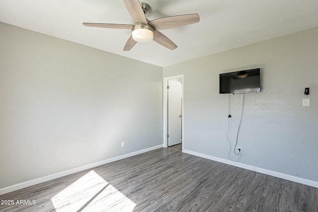 unfurnished bedroom featuring dark wood-style floors, ceiling fan, and baseboards