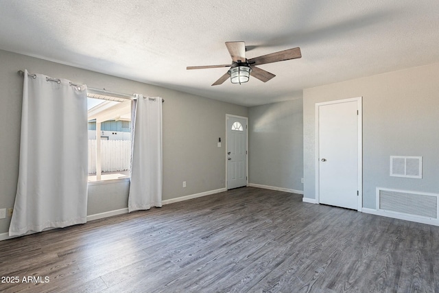 interior space with visible vents, baseboards, and wood finished floors