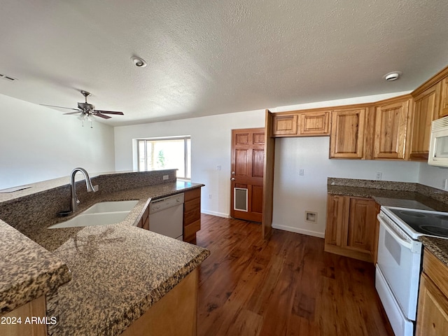 kitchen with white appliances, a textured ceiling, sink, ceiling fan, and dark hardwood / wood-style floors