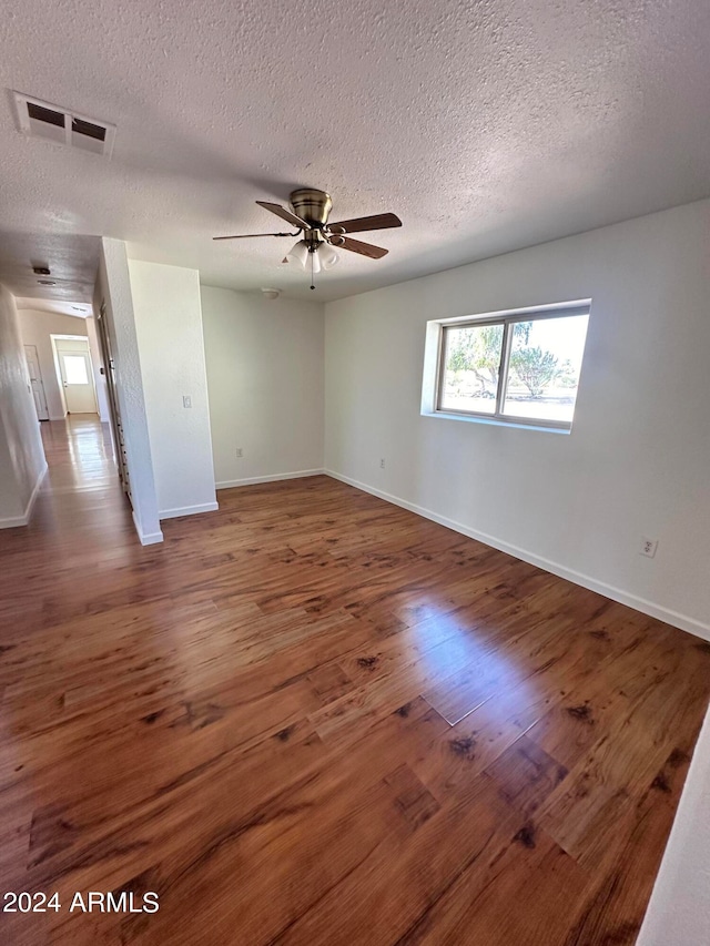 unfurnished room featuring ceiling fan, a textured ceiling, and hardwood / wood-style floors