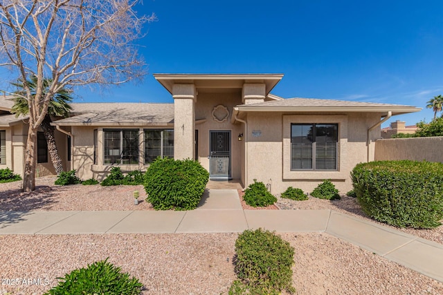 view of front of home with fence and stucco siding