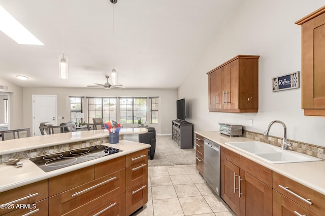 kitchen with brown cabinetry, dishwasher, open floor plan, black electric stovetop, and a sink