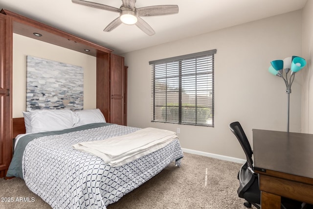 carpeted bedroom with a ceiling fan and baseboards