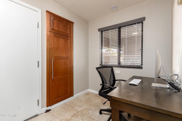 office area with light tile patterned flooring and baseboards