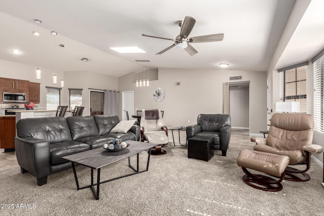 living area featuring a ceiling fan, lofted ceiling, visible vents, and light carpet