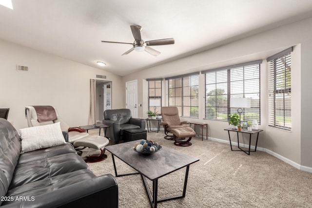 living area with vaulted ceiling, carpet floors, visible vents, and baseboards