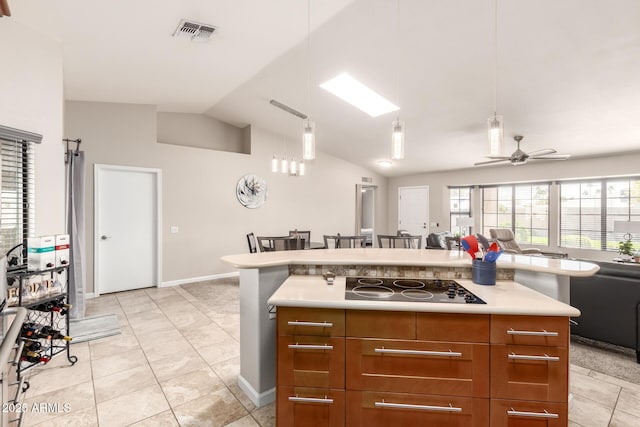 kitchen with visible vents, lofted ceiling, open floor plan, black electric stovetop, and light countertops