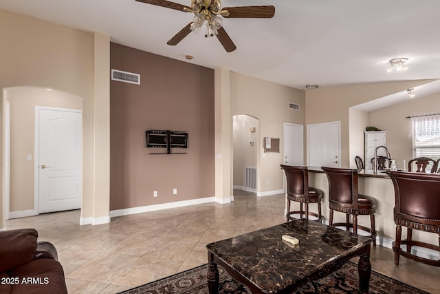 1395 E Runaway Bay Dr, Chandler, AZ 85249 - living area featuring arched walkways, ceiling fan, and baseboards