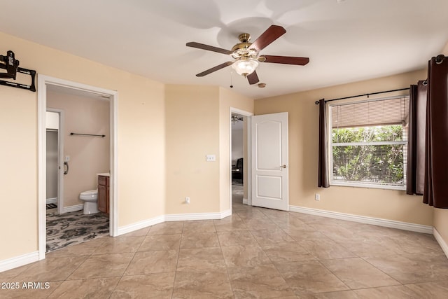1395 E Runaway Bay Dr, Chandler, AZ 85249 - unfurnished bedroom featuring ensuite bath, a ceiling fan, baseboards, and light tile patterned flooring