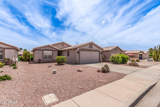 1395 E Runaway Bay Dr, Chandler, AZ 85249 - mediterranean / spanish-style home featuring driveway, a tile roof, stucco siding, and a garage