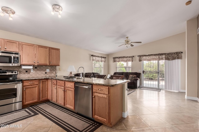 1395 E Runaway Bay Dr, Chandler, AZ 85249 - kitchen with appliances with stainless steel finishes, a sink, a peninsula, light tile patterned floors, and open floor plan