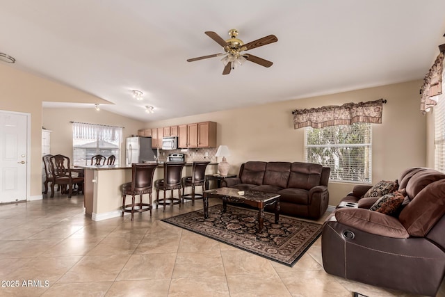 1395 E Runaway Bay Dr, Chandler, AZ 85249 - living room featuring vaulted ceiling, ceiling fan, light tile patterned flooring, and baseboards