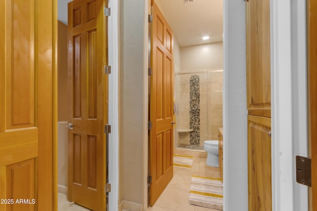 hall with light tile patterned floors, visible vents, and recessed lighting