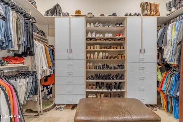 walk in closet with light tile patterned floors