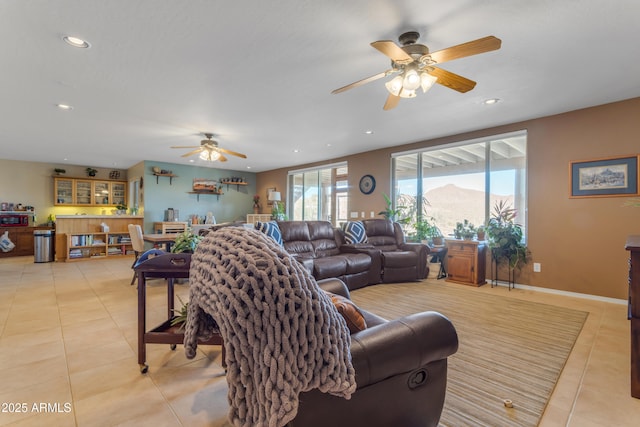 living room with a ceiling fan, light tile patterned flooring, recessed lighting, and baseboards