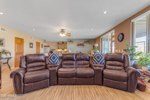 living area featuring light tile patterned floors, visible vents, recessed lighting, and ceiling fan