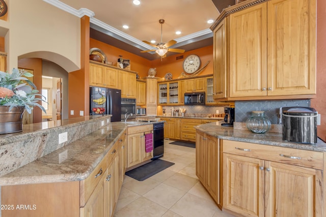 kitchen with arched walkways, freestanding refrigerator, ornamental molding, black microwave, and backsplash