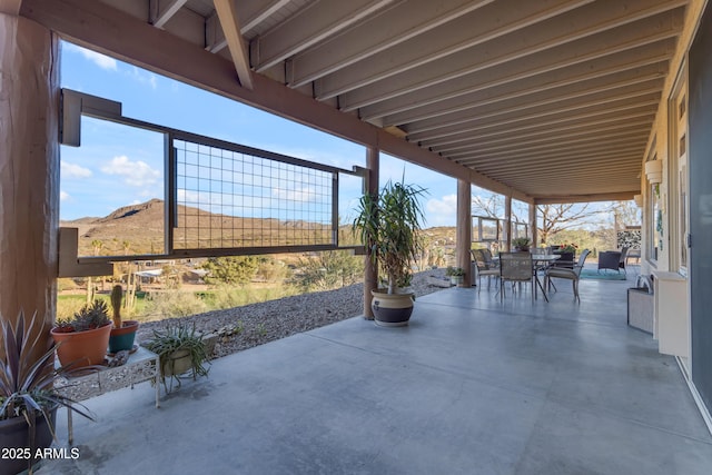 view of patio / terrace with outdoor dining space and a mountain view