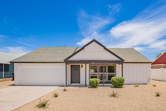9855 S 47th Pl, Phoenix, AZ 85044 - view of front of property featuring roof with shingles, an attached garage, driveway, and board and batten siding
