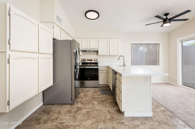 3324 S Parkside Dr, Tempe, AZ 85282 - kitchen with appliances with stainless steel finishes, a peninsula, under cabinet range hood, a ceiling fan, and light countertops