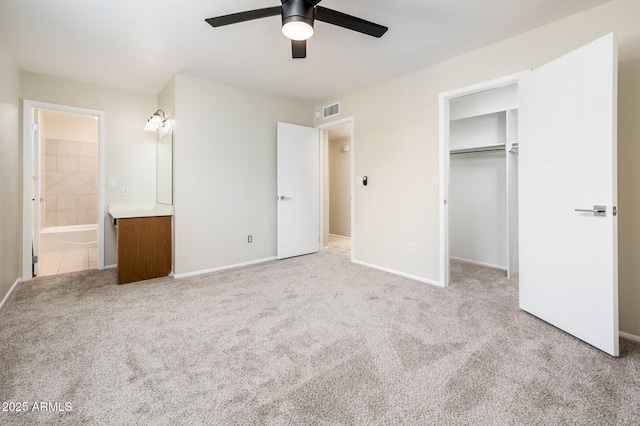 3324 S Parkside Dr, Tempe, AZ 85282 - unfurnished bedroom with light colored carpet, ensuite bath, a spacious closet, a ceiling fan, and a closet
