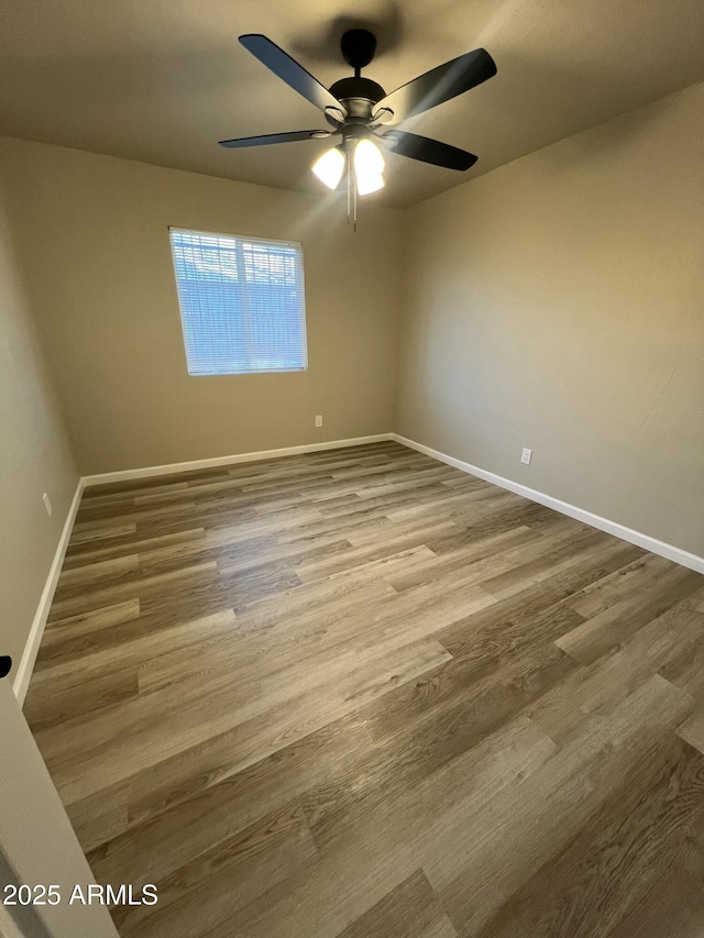 empty room with ceiling fan and wood-type flooring