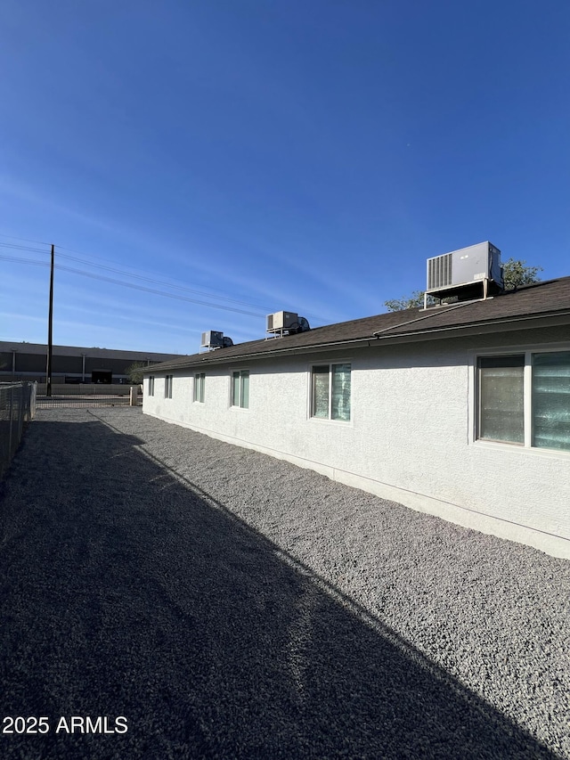 view of side of property with central AC