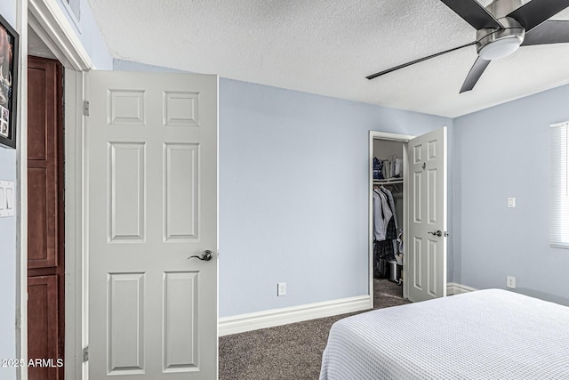 3825 E Camelback Rd Unit 152, Phoenix, AZ 85018 - carpeted bedroom with a textured ceiling, baseboards, a closet, a spacious closet, and ceiling fan