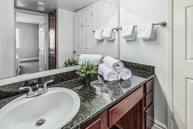 3825 E Camelback Rd Unit 152, Phoenix, AZ 85018 - bathroom featuring vanity, a textured wall, and baseboards